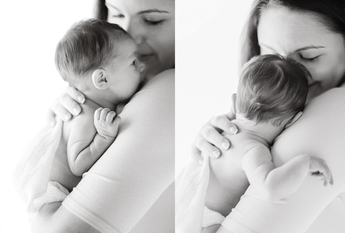 savannah newborn photographer. black and white photograph of mom holding newborn baby girl 