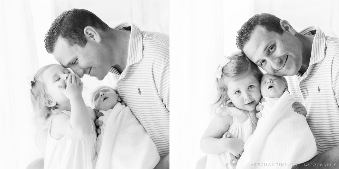 Black and white images of dad holding newborn and hugging two year old in newborn photography studio in savannah georgia 